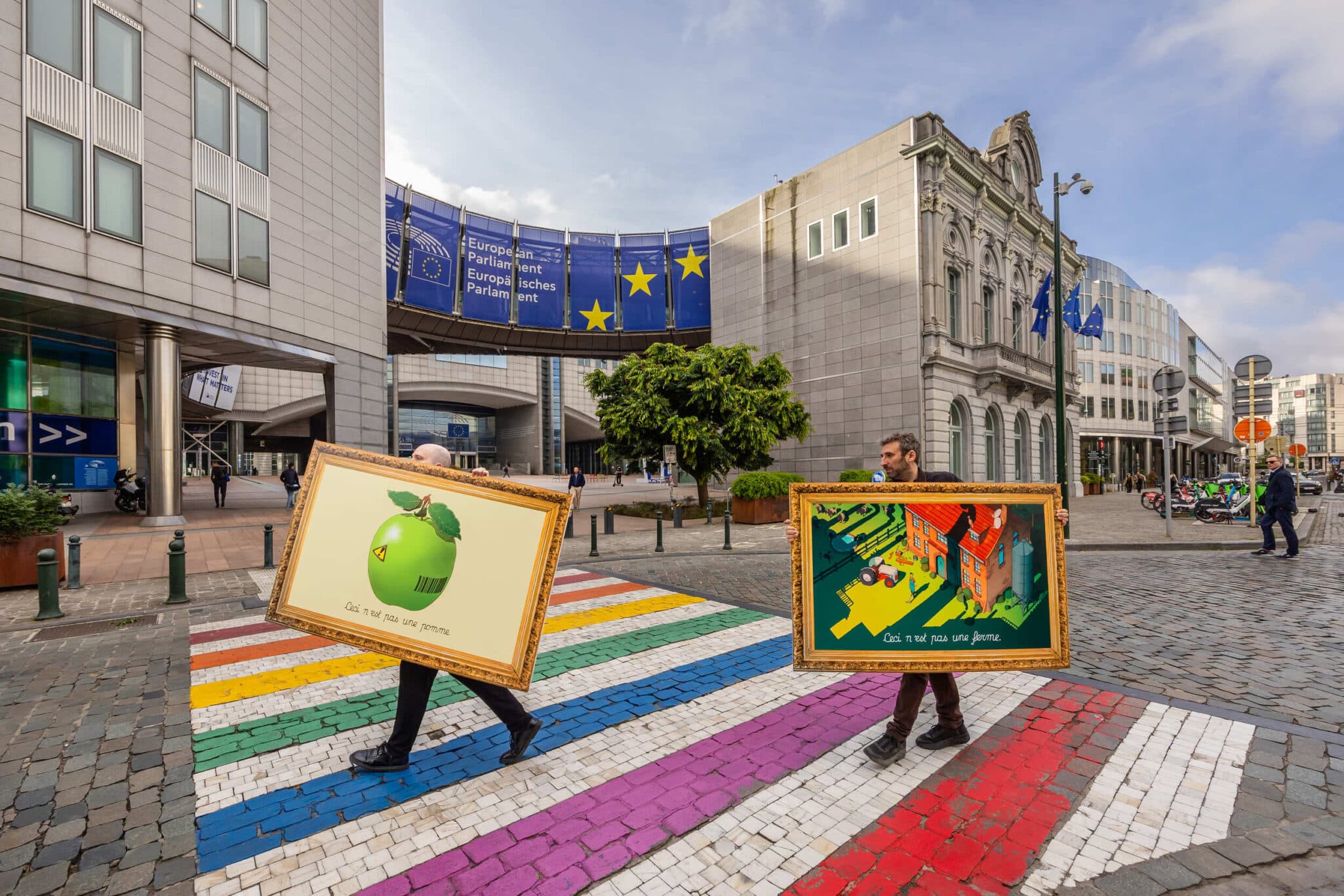 A series of Magritte-inspired Surrealist artwork appeared outside the European Parliament – confronting policymakers with a visual warning about the future of farming in Europe, and a call to align the EU’s €386 billion farm subsidy system with the Green Deal. WeMove Europe, the independent campaign group made up of more than 750,000 people across Europe behind the stunt, have called for urgent CAP reform — demanding fairer subsidies, stronger market regulation, and greater support for sustainable, small-and medium-sized farms. The action is backed by a coalition of farmer groups, environmental organisations and over 100,000 citizens across Europe. They argue the current subsidy system rewards intensive agriculture at the expense of small and sustainable farms. Share The action is backed by a coalition of farmer groups, environmental organisations and over 100,000 citizens across Europe. They argue the current subsidy system rewards intensive agriculture at the expense of small and sustainable farms. More than five million farms have disappeared across the EU since 2005, while 80% of CAP funds go to just 20% of recipients. Polling released earlier this year shows up to 70% of farmers in Spain, Italy and Poland feel forgotten by policymakers — despite most expressing pride in their work and support for environmental action. Morgan Ody, a vegetable producer from Bretagne, France, and member of European Coordination Via Campesina (ECVC), says: “Alongside ensuring fair prices, a strong CAP budget is essential to tackle the challenges farmers face today. But that public money must be used to keep rural areas alive by regulating markets and supporting the transition to agroecology and more sustainable food systems – not to fuel the industrialisation of farming or line shareholders’ pockets.” Styled in homage to Magritte’s famous ‘Treachery of Images’, the artworks unveiled carry captions such as “Ceci n’est pas une pomme” and “Ceci n’est pas une ferme”. Their message: Europe’s farm policy no longer feeds people — it feeds corporate consolidation. The full collection is viewable at www.notfarming.com. The aim is to challenge outdated “postcard” perceptions of farming — and spark honest discussion among policymakers about who the current system really serves. In many European areas, one in three farms has ceased operations, while subsidised overproduction drives prices so low that some farmers earn less than it costs them to produce. In France and Spain, for example, milk is often sold below production cost — a market failure propped up by the CAP. Giulio Carini, communications manager at WeMove Europe says: “Our farming system is rigged. Small farmers are being pushed off the land while agribusiness giants cash in on public money. Discussions about the future of the CAP need to address what we are paying for, not just how much money is allocated to it. We need to support farmers and reward them for protecting our nature and climate, on which they rely. We’re calling on people across Europe to stand up for fair prices, healthy food, and a future where small sustainable farmers and nature can thrive. This is our moment to demand our EU leaders fix this broken system.” In full, the coalition is calling for: Fair prices for farmers that reflect the full cost of sustainable food production Stronger market regulation, including supply management and minimum price guarantees Greater support for small and medium-sized farms over industrial agribusiness A just transition to agroecology to protect soil health, climate, biodiversity, and food sovereignty Access to healthy, sustainable food for all, ensuring that good food is affordable and available, and that people can make real choices about what they eat, without hidden environmental or health costs. These reforms are essential not only for securing farmers’ futures, but also for delivering on the EU Green Deal — ensuring that Europe’s food system supports climate, nature and communities alike.